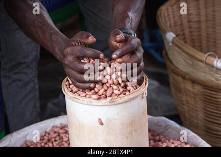 Seau d'arachides décortiquées mesuré pour la vente dans un marché de rue Banque D'Images