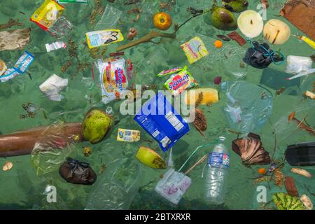 Déchets plastiques et pollution flottant dans la mer au large de la plage à l'île de Mabul, Sabah, Bornéo, Malaisie. Banque D'Images