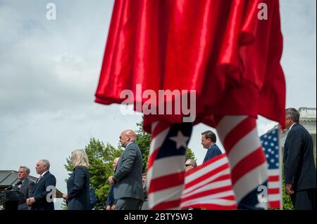 Michael Wheeler, de Kansas City, Mo, porte sa tenue « Super Jesus » avec le cap et le drapeau américain, tandis que le député de la Chambre des représentants, Kevin McCarthy (R-Calif.), détient une disponibilité médiatique avec Steve Scalise (R-LA), le député de la Chambre des représentants de la minorité, Liz Cheney (R-WY) et d'autres, Annoncer que les dirigeants républicains ont intenté une action en justice contre la Présidente de la Chambre Nancy Pelosi et les responsables du Congrès afin d'empêcher la Chambre des représentants d'utiliser un système de vote par procuration pour permettre le vote à distance pendant la pandémie du coronavirus, à l'extérieur du Capitole des États-Unis à Washington, DC. Banque D'Images