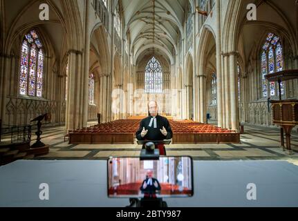 Le Revd Michael Smith, le pasteur Canon de York Minster, répète un service numérique Evensong à l'intérieur de la cathédrale, alors que le gouvernement se dirige vers l'introduction de mesures pour sortir le pays de l'isolement. Banque D'Images