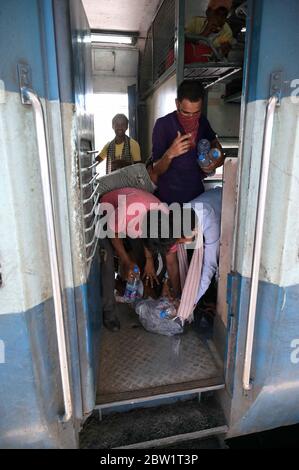 Prayagraj, Uttar Pradesh. 29 mai 2020. Prayagraj: Les migrants se sont donné une bouteille d'eau fournie par le chemin de fer à la jonction de Prayagraj, pendant le confinement en cours de la COVID-19, à Prayagraj, le vendredi 29 mai 2020. Credit: Prabhat Kumar Verma/ZUMA Wire/Alamy Live News Banque D'Images