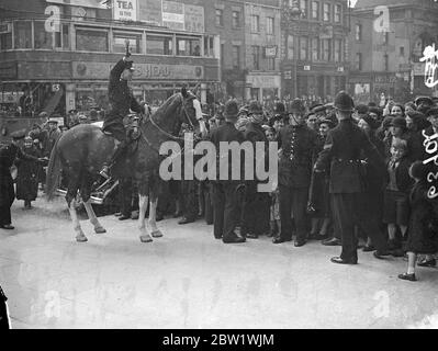 Le duc et la duchesse de Kent au concert Coronation dans East End. La police montée contrôle la foule. Le duc et la duchesse de Kent ont assisté à un concert pour enfants au People's Palace, Mile End Road. Le programme comprenait un morceau spécial de Coronation de Sir Walford Davies, maître de la musique Kings, dédié à la princesse Elizabeth (qui a 11 ans aujourd'hui) et à la princesse Margaret Rose. Des expositions de photos, la police contrôlant les foules qui se sont emprises devant le duc et la duchesse. 21 avril 1937 Banque D'Images