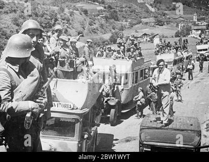 Nouvelles photos des attaques des rebelles sur Bilbao. Combat à plus de 21 kilomètres de l'avant. Avec des avions et des voitures blindées, les troupes rebelles du général Mola font une poussée déterminée sur Bilbao, capitale de la province basque du nord de l'Espagne. Des combats acharnés font rage depuis de nombreux jours dans les villages autour de Bilbao, et les combats se déroulent sur un front de 21 km. Spectacles de photos : les troupes rebelles sont vues à travers un village sur le chemin du front de Bilbao. Leurs transports sont de vieux bus commandités par les autorités de Rebel. 3 juin 1937 Banque D'Images