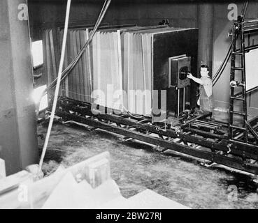 La plus grande caméra de traitement au monde pour le travail en couleur fonctionne sur rail. Occupe deux pièces, traitées à l'électricité. Une caméra de procédé géante pour le travail en couleur, considérée comme la plus grande au monde, a été installée à Cleveland, Ohio. Pour 5000 €, la caméra est si grande qu'elle occupe deux pièces. L'écran en verre de mise au point est situé dans une pièce et dans le reste de la caméra et dans l'autre. Les soufflets électriques fonctionnent sur une voie plus large qu'une voie ferroviaire standard. Le jeu utilisé est de 5 pieds carrés et est placé en position par électricité. Les soufflets de la caméra mesurent 5 pieds, 10 x 5' 6 pouces et peuvent Banque D'Images