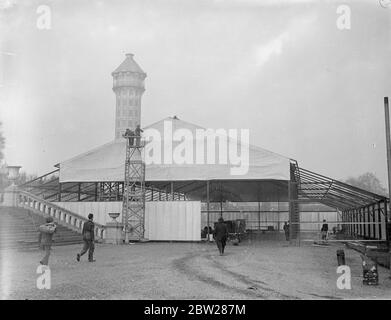 Crystal Palace est d'avoir une autre exposition. Alors que les ouvriers sont encore en train de retirer les ruines de l'ancien Crystal Palace, détruit par un incendie en 1936, d'autres ouvriers dressent des pavillons pour l'ouverture de l'exposition du sud de Londres sur le terrain en mars prochain. Des spectacles photo, l'un des pavillons de l'exposition du Sud de Londres, qui s'élève sous la tour de l'ancien Palais de Cristal. 8 janvier 1938 Banque D'Images