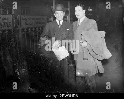 Jock McAvoy accueil après le titre de combat à New York . Jock McAvoy , le champion britannique de taille moyenne , qui a été récemment battu sur des points par John Henry Lewis l'américain coloré , pour le Championnat du monde de lumière Heavyweiht , est arrivé à Londres à son retour de New York . Il a légèrement blessé la main , mais il va s'entraîner pour son match avec Jack Petersen , le champion britannique de poids lourd . Photos , Jock McAvoy photographié à l'arrivée à Waterloo . 25 mars 1936 Banque D'Images