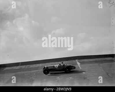 John Cobb sur la banque à Brooklands . La réunion internationale du Brooklands automobile Racing Club , qui a été reportée du lundi de Pâques , en raison du mauvais temps , s'est tenue à Brooklands , Surrey aujourd'hui ( samedi ) . Photos montre , John Cobb ( Sunbeam ) haut sur la banque de chemin de fer dans le deuxième handicap long de Pâques . 18 avril 1936 Banque D'Images