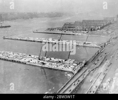 Où la reine Mary sera Berth à New York quand dans quelques heures la reine Mary arrive à New York après sa première traversée de l'Atlantique - un voyage que l'on espère accomplir en un temps record - elle couchera à l'embarcadère n° . 90 dans la rivière Nord . Le quai a été spécialement construit avec deux autres grâce à une subvention de près de 300 000 £ de l' Administration du travail public . Un des couchettes est utilisé par le géant français Normandie . Photos : UNE vue générale des nouveaux jetées pour la reine Mary et la Normandie dans la rivière Nord de New York . 1er juin 1936 Banque D'Images