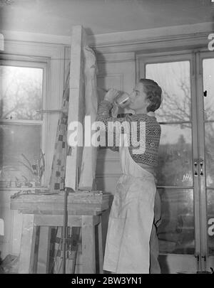 London Woman conçoit une fenêtre de 30 pieds de haut pour l'exposition British Pavilion à Paris. Une fenêtre de 30 pieds de haut de verre sculpté, un processus entièrement nouveau, avec le motif Britannia à la conception de Gertrude Hermes de Londres est incorporé dans le pavillon britannique en construction à Paris pour la grande exposition internationale des arts et de l'industrie qui ouvre en mai. La fenêtre fait face à la place d'Honneur de l'exposition. Photos: Gertrude Hermes, designer de la fenêtre du pavillon britannique au travail dans son studio londonien. 27 janvier 1937 Banque D'Images