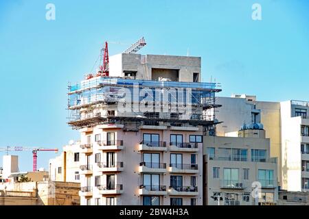 Un échafaudage entoure les deux étages supérieurs d'un immeuble à Sliema à Malte Banque D'Images
