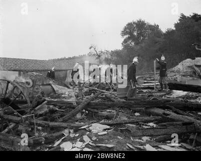 Feu de ferme Padham à Swanley . Travail de pompier à travers les restes charrés . 1936 Banque D'Images