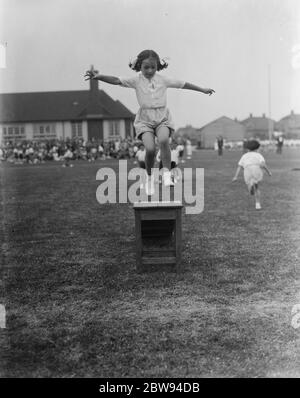 Journée sportive à l'école de bébé Days Lane à Sidcup , Kent . Une petite fille saute sur une boîte . 1937 Banque D'Images