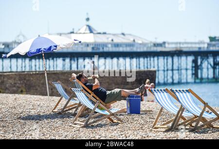 Brighton UK 31 mai 2020 - temps pour une bière sur une autre belle journée ensoleillée sur la plage de Brighton pendant la crise pandémique du coronavirus COVID-19 . Crédit : Simon Dack / Alamy Live News Banque D'Images