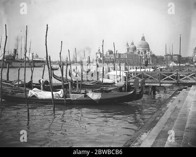 Venise . Gondoles amarrées à l'entrée du Grand Canal montrant l'église de Santa Maria della Salute en arrière-plan . Banque D'Images