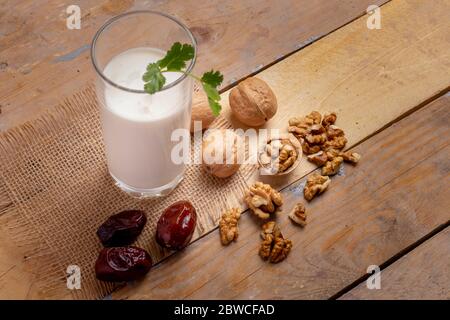 Le lait végétalien des noix dans le verre sur une table en bois, petit déjeuner sain Banque D'Images