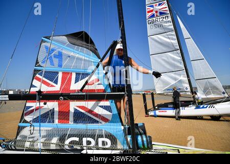 L'athlète de Tokyo 2020 Saskia Tidey preps la voile principale sur son 49er FX pour une session d'entraînement comme membres de l'équipe GB à Weymouth et Portland National Sailing Academy de retour à l'entraînement sur l'eau en paires comme restrictions de verrouillage facilité en Angleterre. Banque D'Images