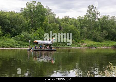 Les gens se détendent sur un radeau primitif pendant le rafting sur la rivière. Touristes rafting, flottant. Russie, Bashkortostan, juillet 2019. Banque D'Images