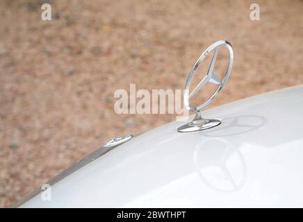 Gros plan de l'emblème de capot métallique Mercedes Benz à l'extérieur sur le capot de la voiture. Banque D'Images