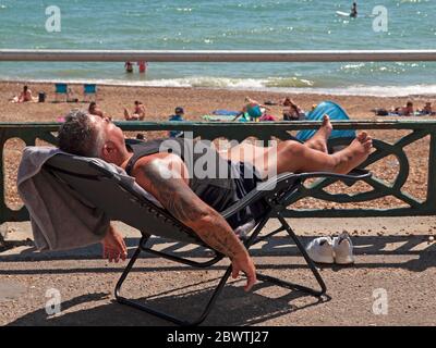 Profitez du soleil sur la plage de Brighton Banque D'Images