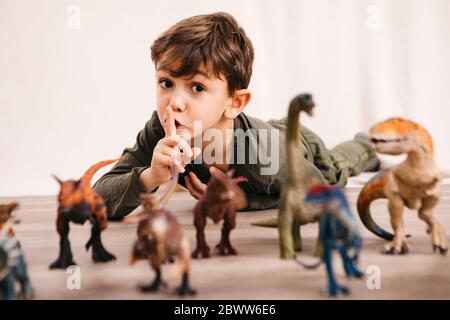 Portrait d'un petit garçon jouant avec des dinosaures en tant que jouet Banque D'Images