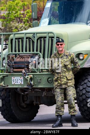 Saint John, Nouveau-Brunswick, Canada - le 10 juin 2018 : Journée communautaire de Port Saint John. Un soldat se tient devant un grand camion militaire. Banque D'Images