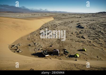 Installation du camp vue depuis le sommet d'une dune de sable. Safari dans le désert en 4x4 sur la côte des squelettes de Namibie, en Afrique du Sud-Ouest. Banque D'Images