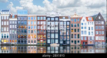 Rangée de maisons de canal authentiques au Damrak dans le centre d'Amsterdam Banque D'Images