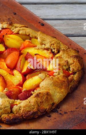 Pâtisserie rustique faite maison à la galette, avec pêches fraîches et abricots Banque D'Images