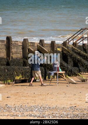 Peinture d'artiste local sur Cromer Beach Banque D'Images