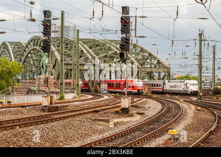 Trois trains traversent le pont Hohenzollern sur le Rhin à la gare centrale de Cologne, en Allemagne Banque D'Images