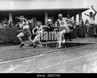 Lors des compétitions de groupe de la sa Berlin-Brandebourg, les hommes de la sa sautent sur un fossé d'eau dans le parcours d'obstacles de 400 M. Banque D'Images