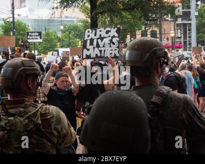 Atlanta, États-Unis. 04e juin 2020. Les gardes nationaux de Géorgie se tiennent avec les membres de l'équipe SWAT de la ville d'Atlanta pour faire respecter un couvre-feu après des jours de manifestations et d'émeutes à la suite de la mort de George Floyd près du parc olympique Centennial le 4 juin 2020 à Atlanta, Géorgie. Floyd a été étouffé par la police à Minneapolis, ce qui a entraîné des manifestations qui ont balayé le pays. Crédit : MSGT. Roger Parsons/Garde nationale/Alamy Live News Banque D'Images