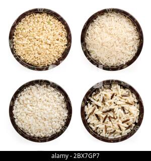 Variétés de riz dans des bols en pierre. Vue de dessus, isolée. Inclut arborio, basmati, brun, grain long et sauvage. Banque D'Images