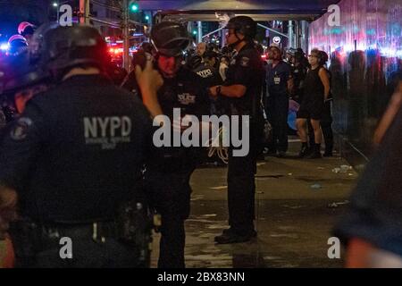 NEW YORK, NY - 03 JUIN : les manifestants à la main sont alignés et traitent avant d'être conduits dans un bus correctionnel sur les lieux d'une arrestation de masse de manifestants Banque D'Images