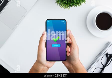 Transferts d'argent rapides. Femme tenant un smartphone avec le message transaction terminée à l'écran Banque D'Images