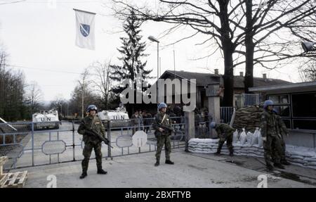 7 mars 1994 pendant la guerre en Bosnie : les soldats suédois de Nordbat 2 gardent sous un drapeau bosniaque aux portes de l'aéroport de Tuzla. Banque D'Images