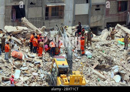 Les responsables de la sécurité ont enfermé dimanche le site de l'incident d'effondrement d'un immeuble résidentiel de six étages alors que l'opération de sauvetage est en cours, situé sur la colonie Liaquat Lyari à Karachi, le lundi 8 juin 2020. Un immeuble résidentiel de six étages s'est effondré dans le marché de Khasda de Lyari, dimanche soir. Quatre corps ont été retirés sous les débris - deux hommes et deux femmes - et 12 personnes ont été blessées lors de l'incident, selon les secouristes.On pense qu'il y avait environ 50 à 60 personnes dans le bâtiment au moment de l'effondrement. Banque D'Images