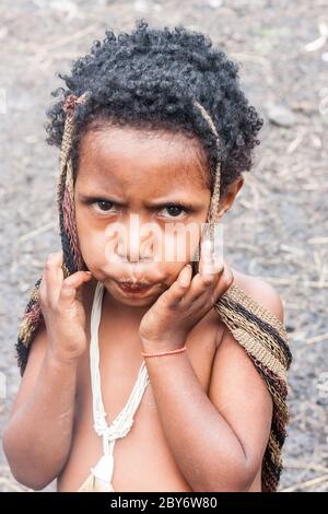 Wamena, Indonésie - 9 janvier 2010 : Portret de Dani tribe enfant. Petite fille à la recherche de l'appareil photo. Baliem Valley en Indonésie, en Papouasie-Nouvelle-Guinée. Banque D'Images