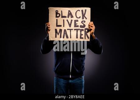 Photo d'afro américain gars fermer couverture face carton bannière démontrer espoir inspirer message pour la tolérance humaine vêtements chandail denim jeans isolés Banque D'Images