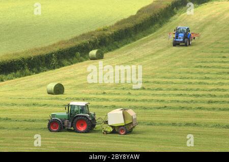 Tracteur dans un champ agricole près de la ville d'Axminster, Devon Banque D'Images