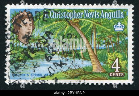 ST. CHRISTOPHER - VERS 1963: Timbre imprimé par la Grande-Bretagne, montre Jungle sur l'île à l'océan, vers 1963. Banque D'Images