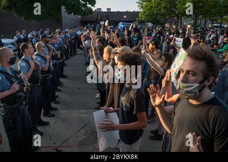 Les policiers de Chicago sont en face avec les manifestants au 24e District police Station, dans le quartier du Rogers Park, à l'extrême nord, le 3 juin 2020. Après un rassemblement communautaire en faveur de la Black Lives Matter, environ 200 manifestants ont poursuivi la manifestation en marchant jusqu'au poste de police de Clark Street où s'est ensuivie une impasse tendue de 30 minutes devant le bâtiment. Les manifestants ont scandé « dites leurs noms », « pas de justice, pas de paix » et d'autres slogans. La ligne des policiers était toujours là et ne disait rien en retour. Finalement, les manifestants se sont enrarés et ont continué à marcher vers le sud sur la rue Clark Banque D'Images