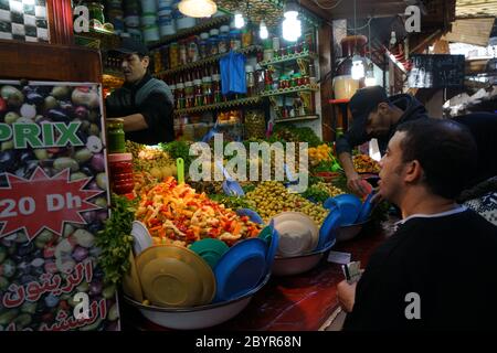 Des olives marinées décorées de légumes multicolores et d'oignons sont en vente dans la médina de Fès (ancienne partie fortifiée d'une ville nord-africaine), au Maroc Banque D'Images