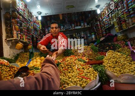 Des olives marinées décorées de légumes multicolores et d'oignons sont en vente dans la médina de Fès (ancienne partie fortifiée d'une ville nord-africaine), au Maroc Banque D'Images