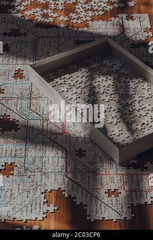 Londres, Royaume-Uni - 18 mai 2020 : boîte avec pièces de puzzle blanches sur le dessus du puzzle avec la carte emblématique du métro de Londres moderne, conçue en 1931 par Henry Banque D'Images