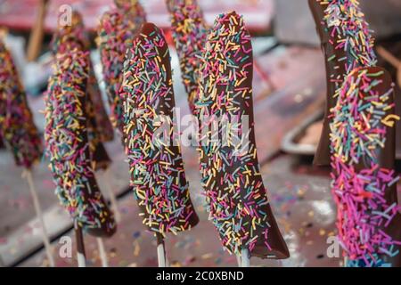 Bananes sucrées en chocolats sur un bâton vendu dans les rues d'Hiroshima au Japon Banque D'Images