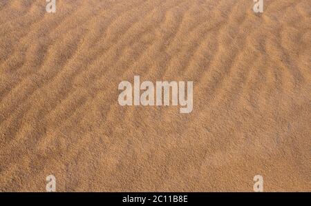Fond de sable près des structures avec des vagues faites par le vent Banque D'Images