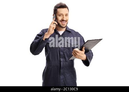 Homme travaillant en uniforme bleu parlant sur un téléphone portable et tenant un presse-papiers isolé sur fond blanc Banque D'Images