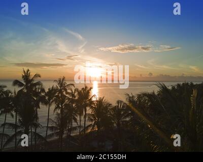 Vue aérienne depuis un drone sur les palmiers et la mer au coucher du soleil. Bali. Indonésie Banque D'Images