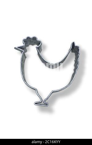 Couteau à pâtisserie en forme de poulet sur une surface blanche Banque D'Images